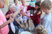 EKU staff help children mix up their own ice cream treat.