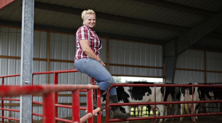 EKU student poses on fence rail