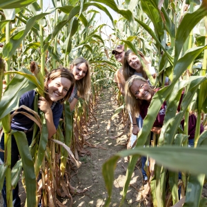 Students pose between corn rows, 2011 Fall Field Day